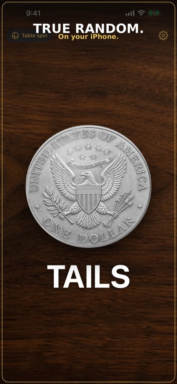 Flip showing a silver dollar on a wood table, landed on tails